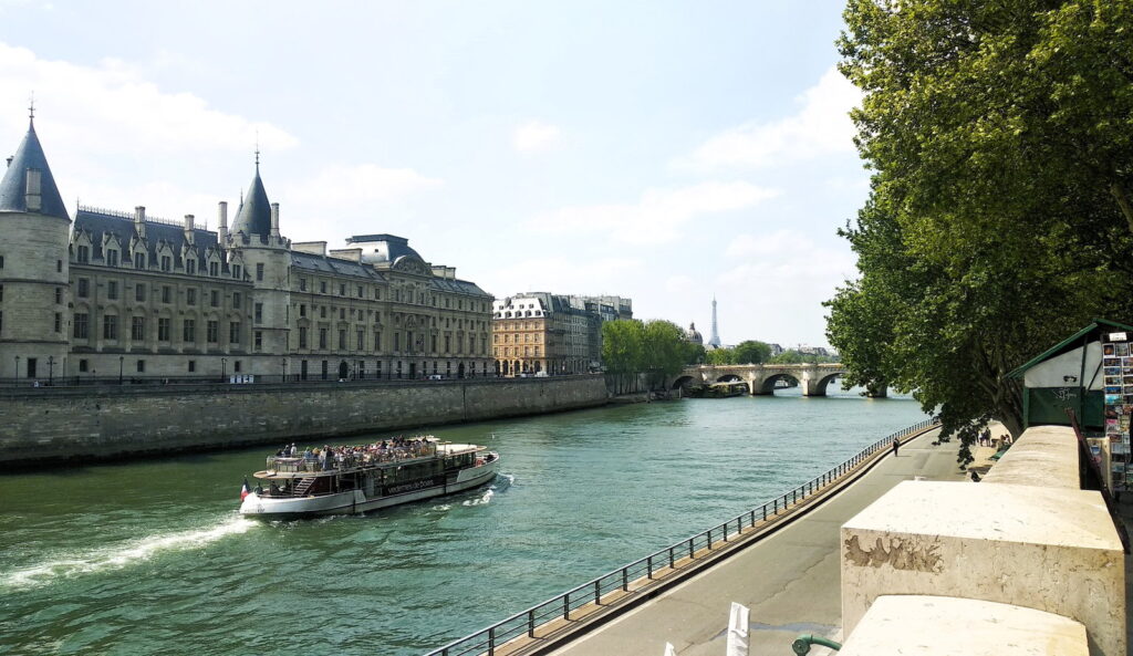 Veduta della Senna con la Conciergerie e un bateau-mouche a Parigi